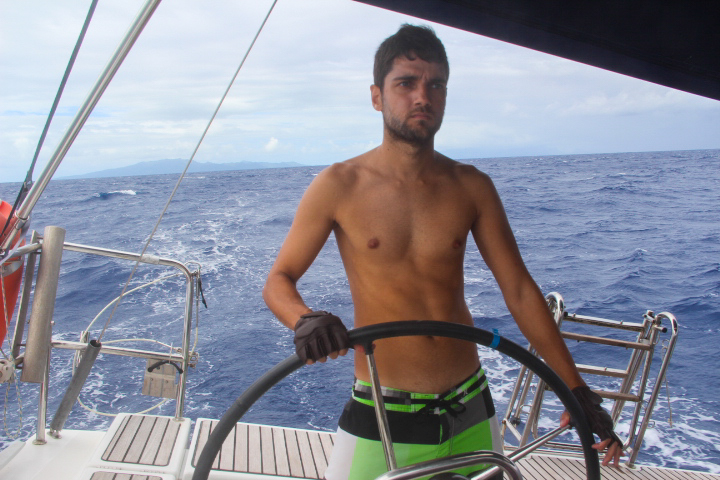 Pedro steering the sailboat to Bora Bora