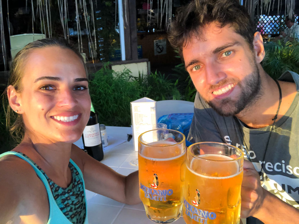 Pedro and Bella with two Hinano cold pints making a toast